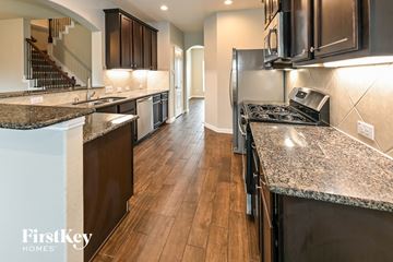 Baytown house for rent - a kitchen with granite counter tops and stainless steel appliances