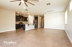 Litchfield Park house for rent - A spacious kitchen and living room with a tiled floor and a ceiling fan.