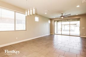 Litchfield Park house for rent - A spacious room with a fan and a sliding glass door.