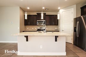 Litchfield Park house for rent - A kitchen with a white island and a refrigerator.