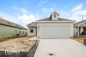 Converse house for rent - the view of the front of a house with a concrete driveway