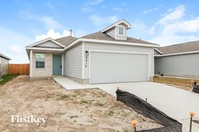Converse house for rent - the front of a house with a driveway and a garage door
