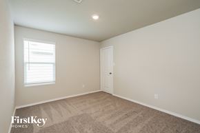 Converse house for rent - a bedroom with a carpeted floor and a white door and window
