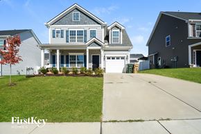 Clayton house for rent - A house with a grey roof and a white garage door is shown.