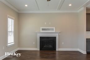 Clayton house for rent - A living room with a fireplace and wooden floors.