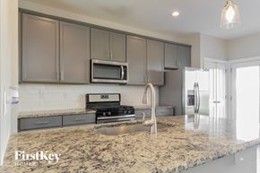 Clayton house for rent - A kitchen with granite countertops and a stainless steel refrigerator.
