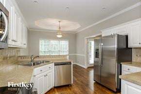 Stanley house for rent - an updated kitchen with stainless steel appliances and white cabinets