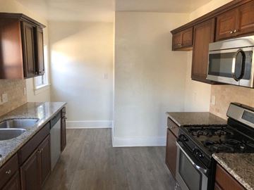 Los Angeles apartment for rent - an empty kitchen with wooden cabinets and stainless steel appliances