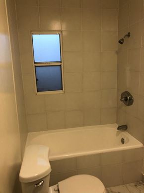 Los Angeles apartment for rent - a bathroom with a toilet and a tub and a window