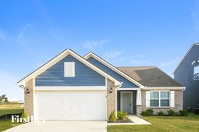Whitestown house for rent - A blue house with a white garage door and a brown brick wall.