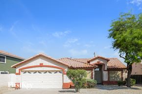 Glendale house for rent - a house with a garage and a tree in front of it