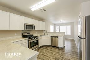 Glendale house for rent - a kitchen with white cabinets and stainless steel appliances