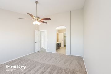 Glendale house for rent - a spacious living room with carpet and a ceiling fan