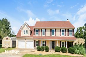 Dallas house for rent - a house with a red roof and white garage doors