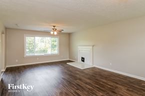 Dallas house for rent - the living room of an empty house with wood flooring and a ceiling fan