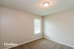 Dallas house for rent - a bedroom with white walls and white carpet and a window