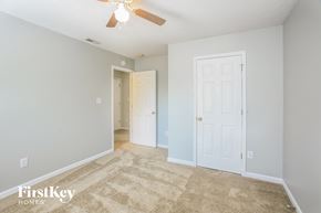 Westfield house for rent - a living room with a white door and a ceiling fan