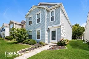 Fishers house for rent - a blue house with a sidewalk in front of it