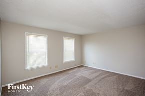 Fishers house for rent - a bedroom with carpet and two windows