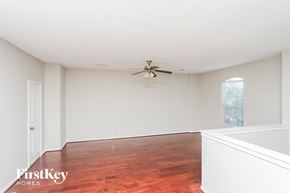 Fort Worth house for rent - an empty living room with wood flooring and a ceiling fan
