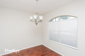 Fort Worth house for rent - a living room with a large window and a wood floor
