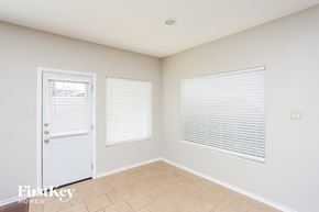 Fort Worth house for rent - a bedroom with a door and two windows and a tiled floor