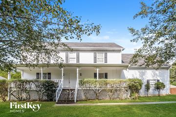 Powder Springs house for rent - a white house with a yard and a fence