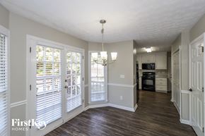 Powder Springs house for rent - an empty living room doors and a kitchen