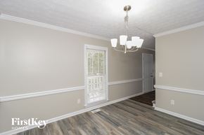 Powder Springs house for rent - the living room of a house with a window and a chandelier
