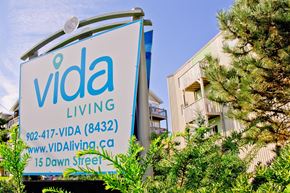 Halifax apartment for rent - A sign for Vida Living with a phone number and website on it.