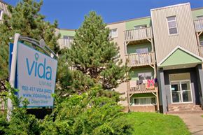 Halifax apartment for rent - A sign for Vida Living in front of a building.