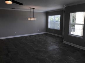 Bradenton house for rent - a living room with grey walls and a large window