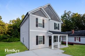 Kannapolis house for rent - the front of a white house with a driveway