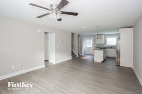 Kannapolis house for rent - a renovated living room with a ceiling fan and a kitchen