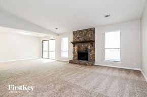 Stone Mountain house for rent - a spacious living room with a fireplace and carpeted flooring