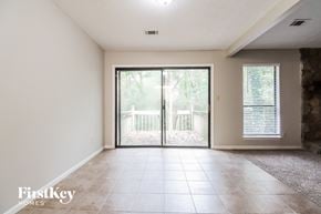 Stone Mountain house for rent - an empty living room with sliding glass doors to a balcony