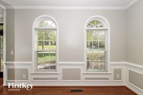 Clemmons house for rent - A room with two arched windows and a wooden floor.