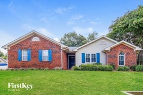 Greensboro house for rent - a brick house with blue shutters and a lawn
