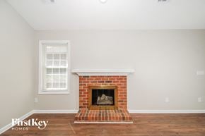 Greensboro house for rent - the living room has a brick fireplace and hardwood floors