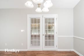 Greensboro house for rent - a living room with white doors and a chandelier
