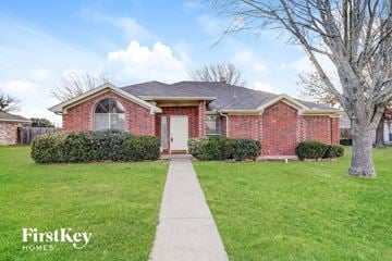 Desoto house for rent - a brick house with a white door and a lawn