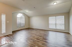 Desoto house for rent - the living room with wood floors and a large window