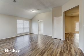Desoto house for rent - the living room and dining room with wood flooring
