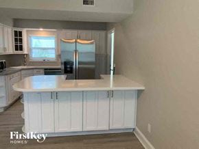 Largo house for rent - a kitchen with a white counter top and a refrigerator