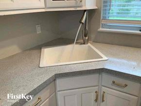 Largo house for rent - a kitchen with a sink and some white cabinets