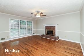 Lawrenceville house for rent - a living room with a fireplace and a ceiling fan