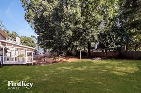 Lawrenceville house for rent - a backyard with trees and a fence and a house