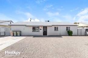 Glendale house for rent - a small white house with a gravel driveway
