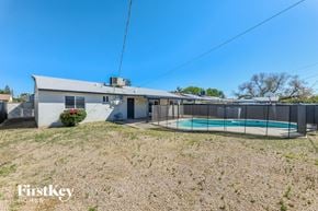 Glendale house for rent - a white house with a pool and a fence