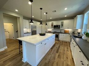 Santa Barbara apartment for rent - A kitchen with white cabinets and a large island.